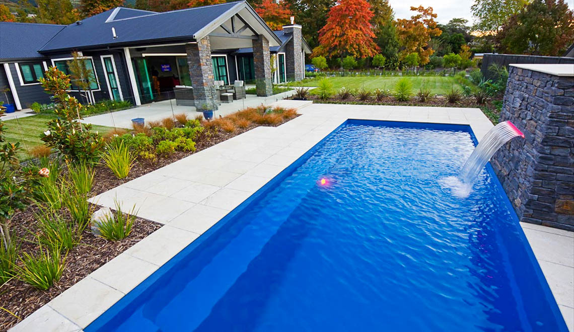 Leisure Pools Harmony fiberglass swimming pool with perimeter safety ledge
